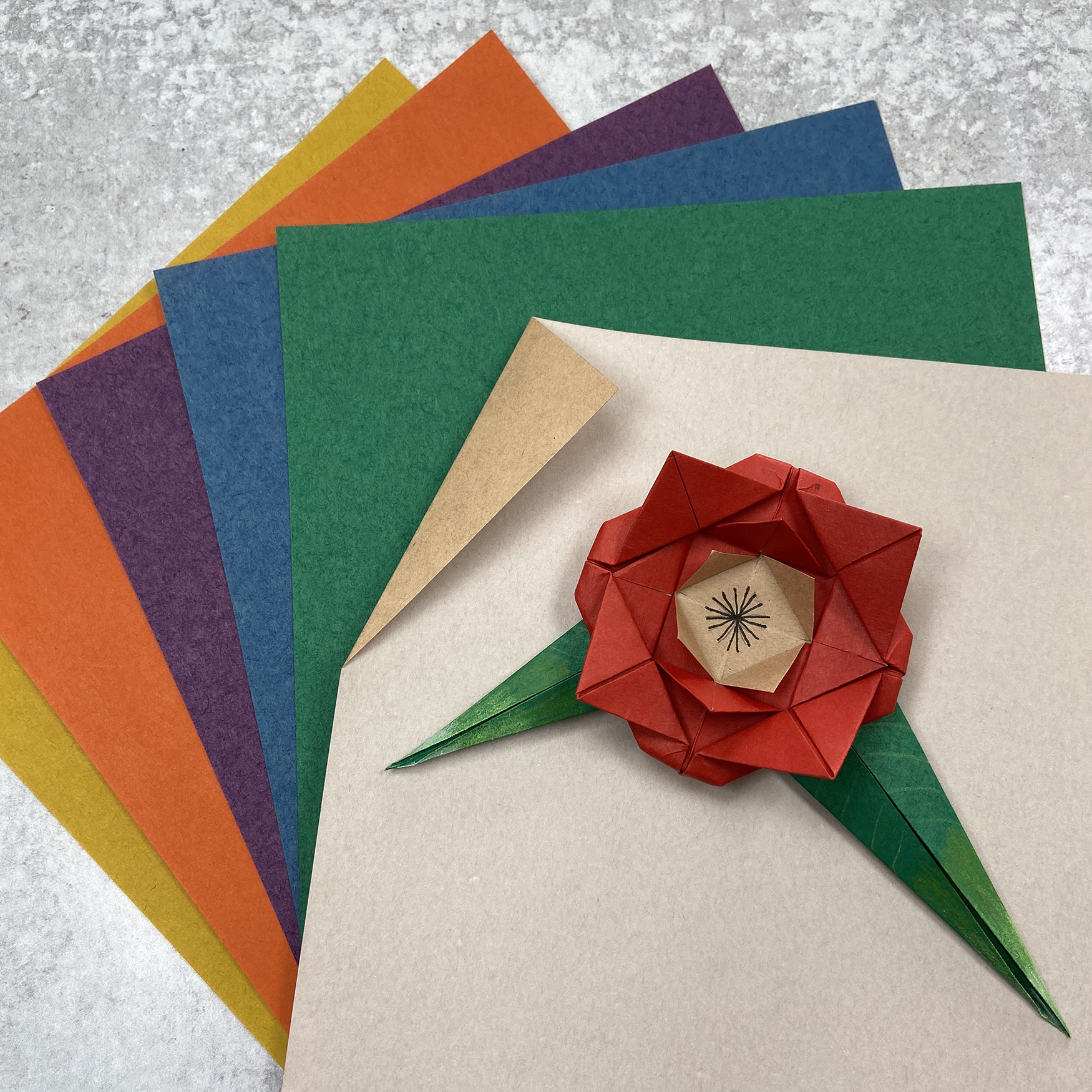 array of colorful origami with an origami rose on top
