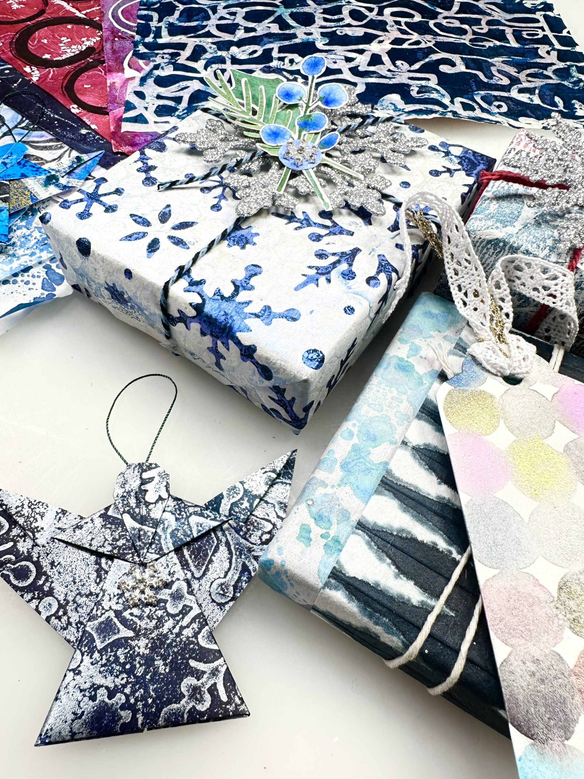 gift wrapped boxes, tags, and origami angel made out of embellished washi paper