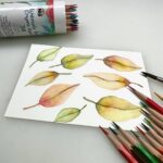 watercolor leaves painting with watercolor pencils around the painting