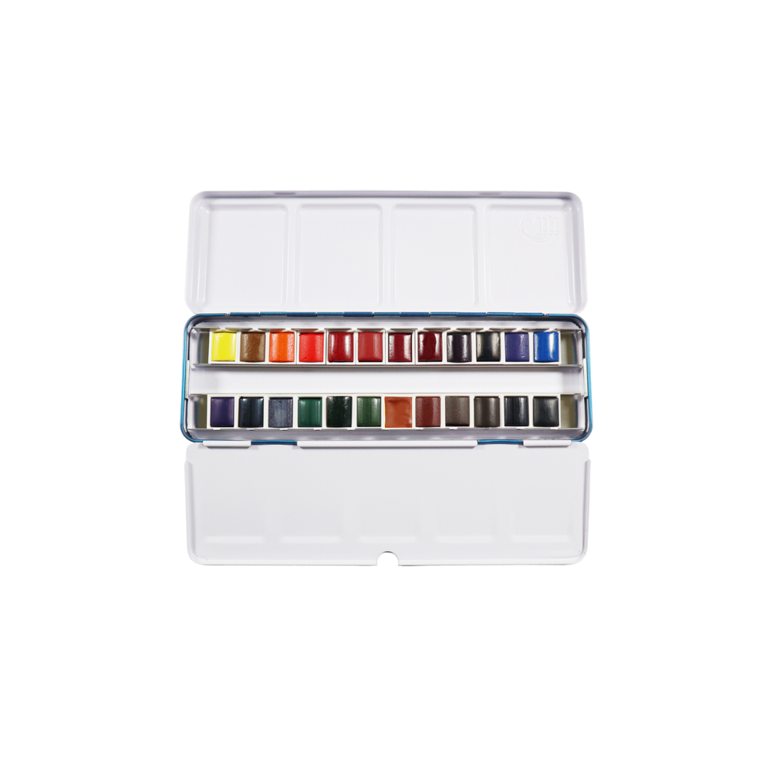 open tin of Niji Artist watercolors Studio set with 24 colors, with closed blue metal watercolor tin in foreground