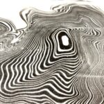 single sheet with wavy rings of black and white suminagashi, or Japanese ink marbling