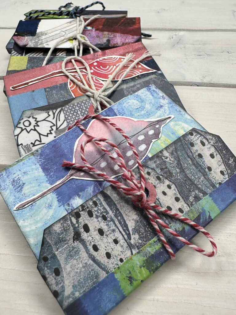 assortment of tag books made with painted papers origami