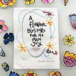 loose florals watercolor painting with the quote "A flower blossoms for its own joy" and watercolor flower cut outs arranged around this