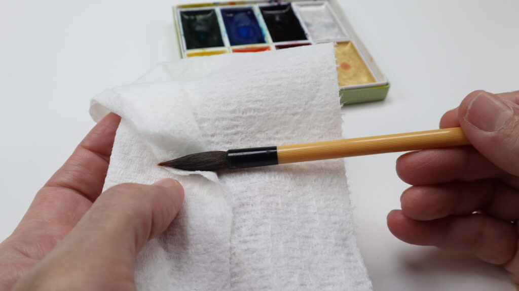 Wa fude brush being dried on a paper towel