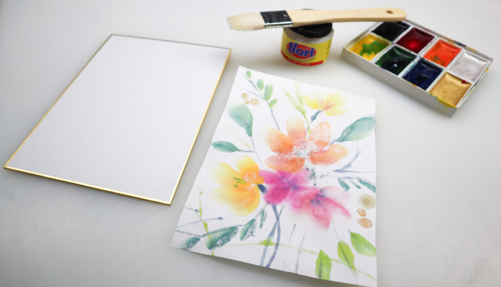 reverse side of a floral painting on Hosho paper beside a shikishi board, gansai set, Nori Paste jar and brush