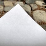 close up picture of the corner of a sheet of Torinoko paper against a background of rocks