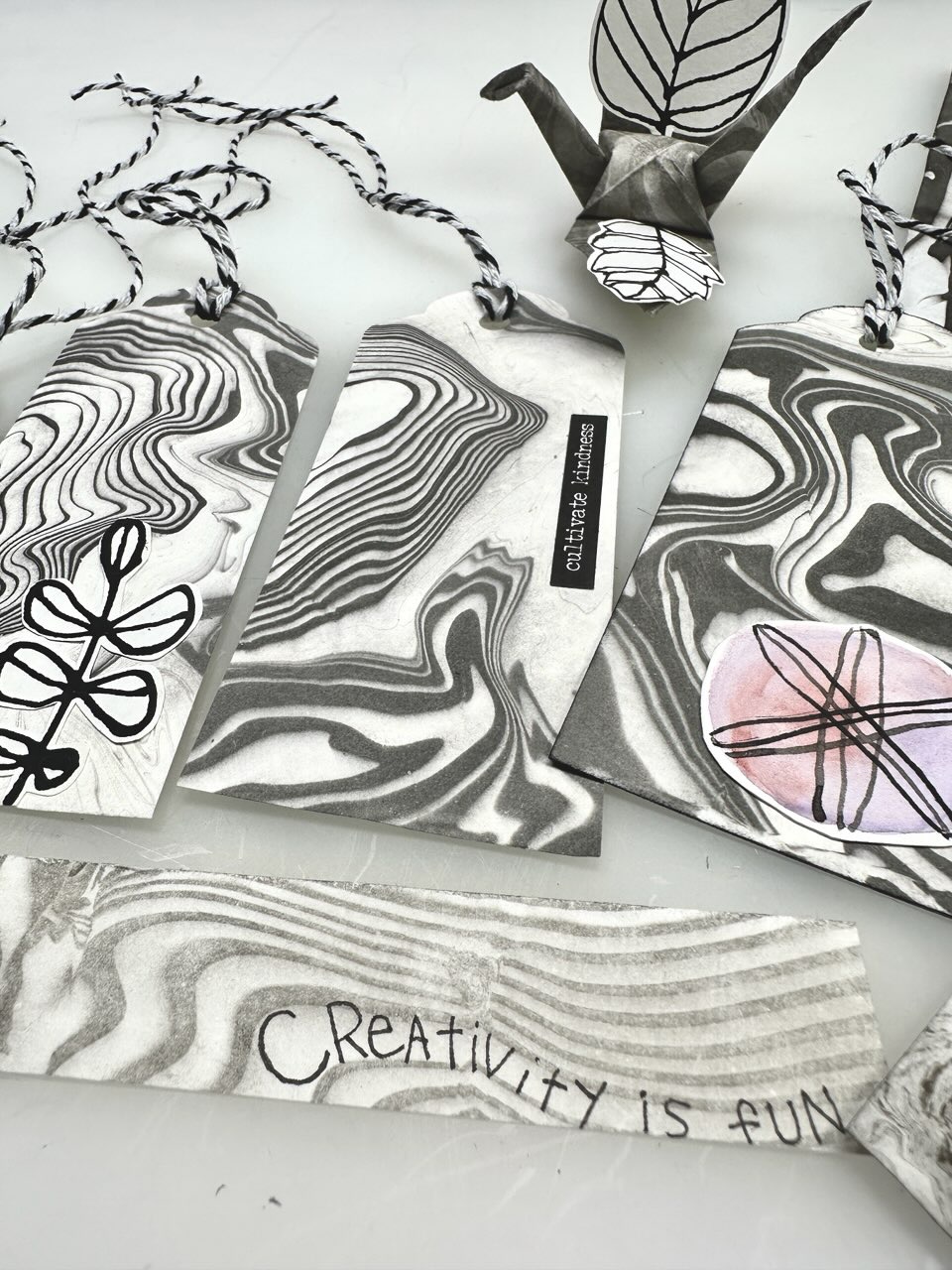 gift tags, origami crane and bookmark made out of suminagashi print paper
