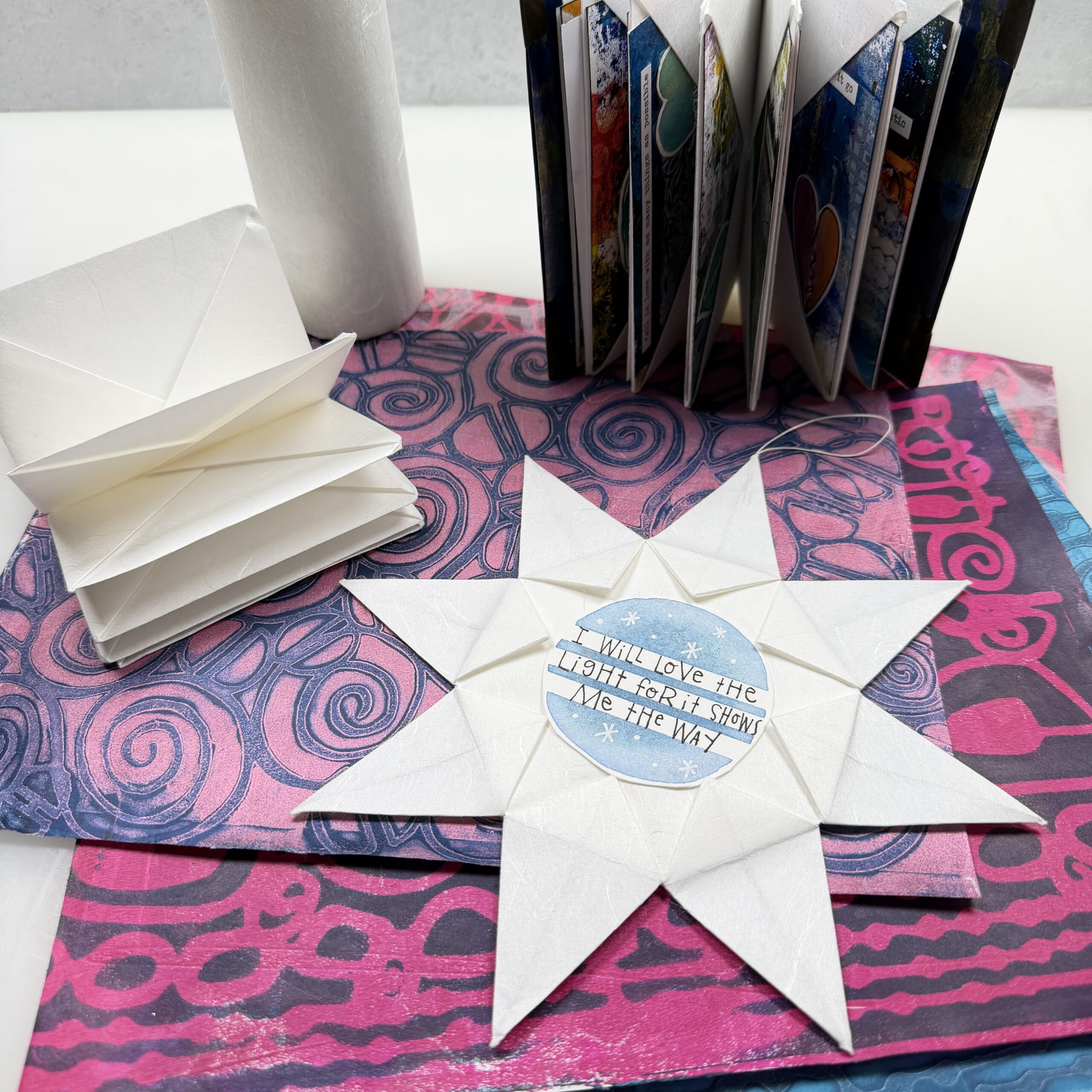origami paper books and star on top of colorful gel printed Unryu washi paper