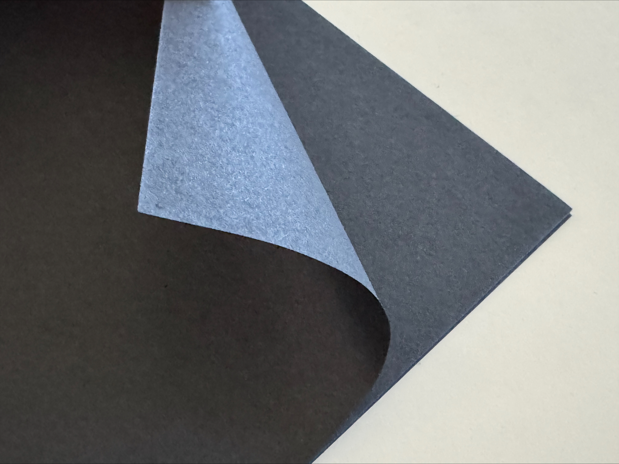 stack of black washi paper with top sheet curved up