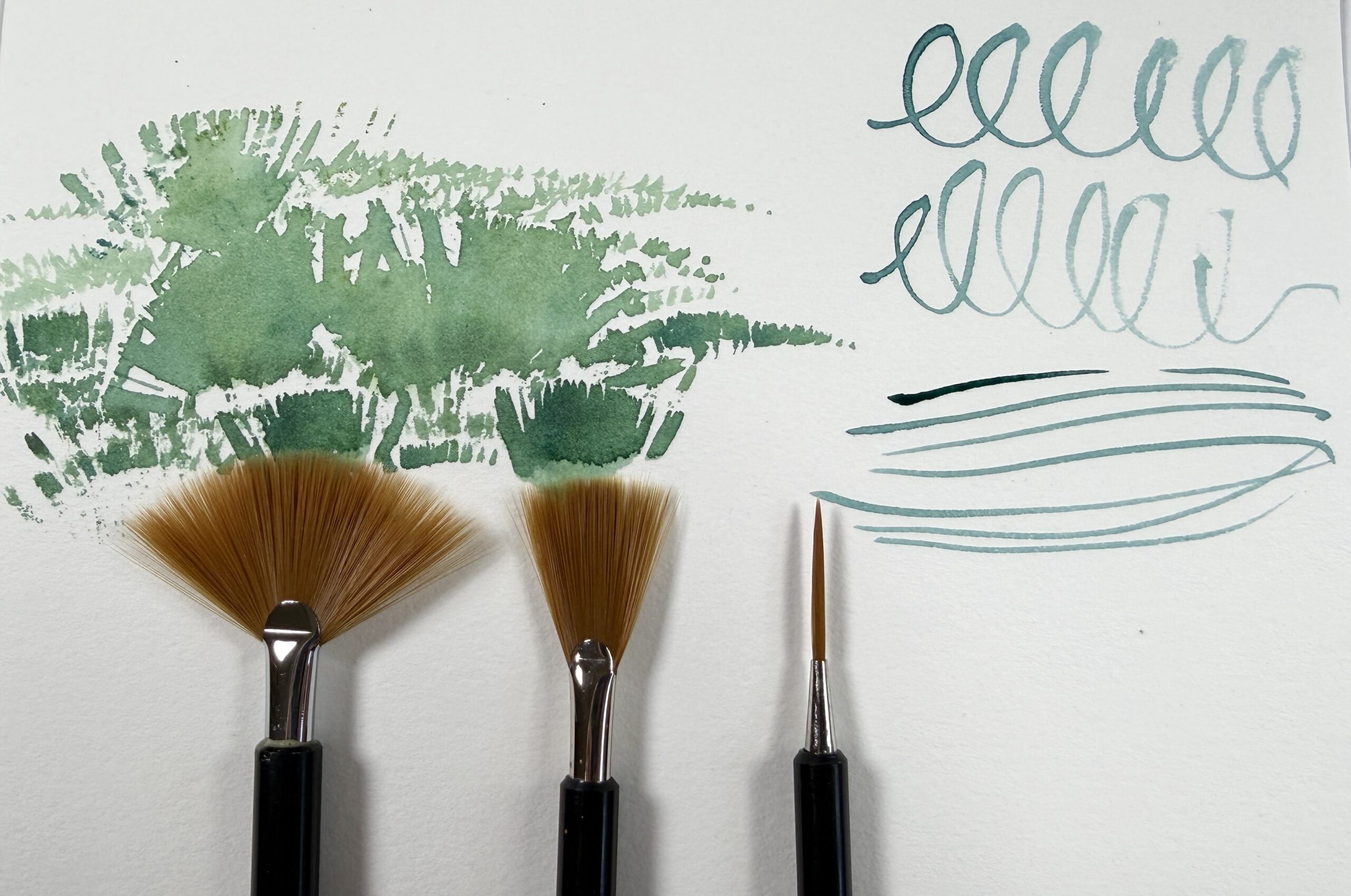 fanned and liner fusion brushes with green watercolor texture marks and blue curlicues and lines