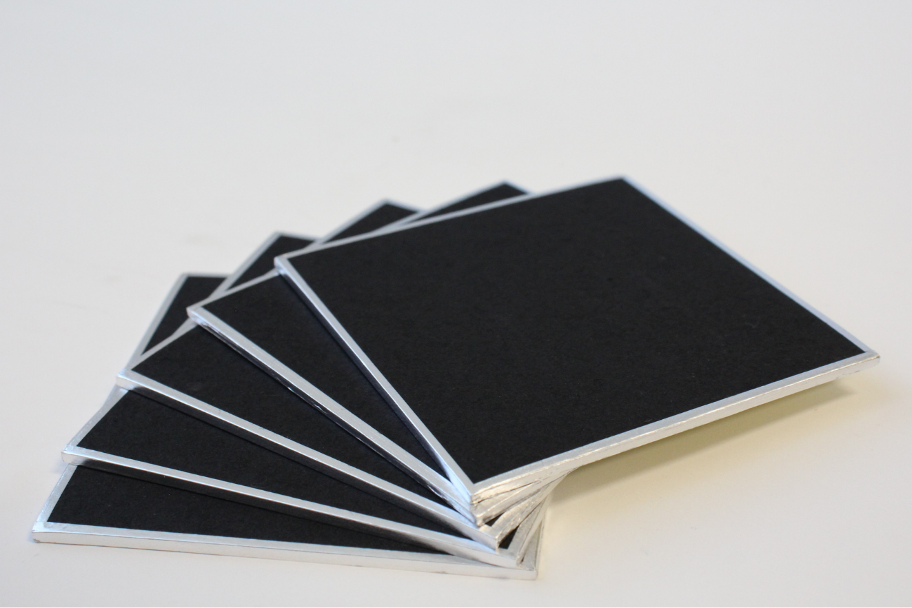 angled photo of five black shikishi board stacked and fanned out