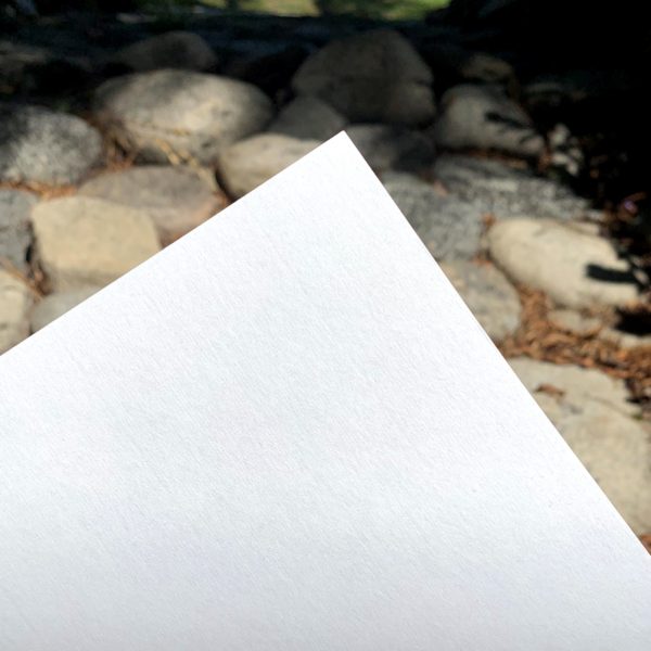 close up of a corner of gasen paper with stones in the background